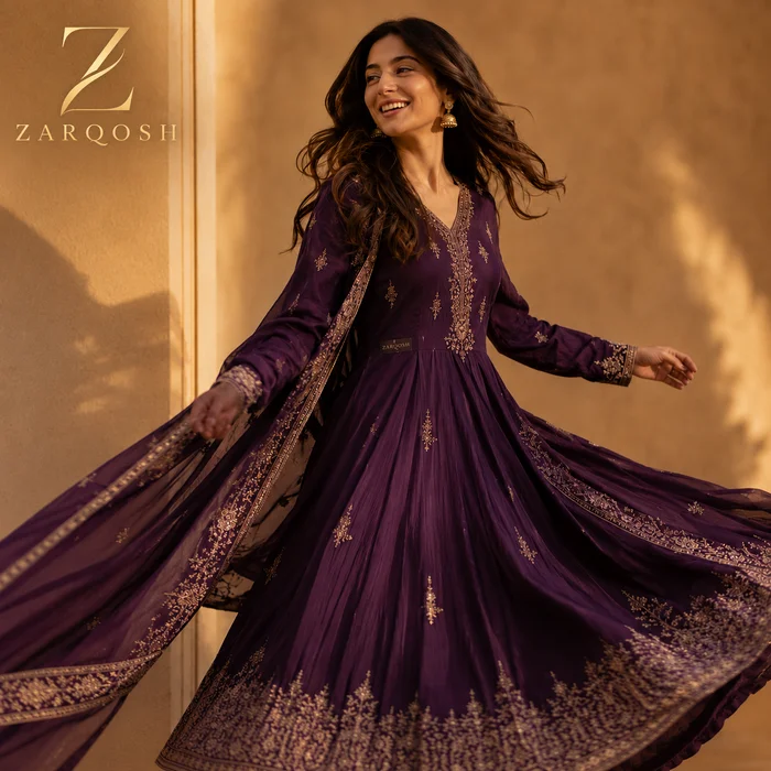 Plum embroidered look moving through warm light